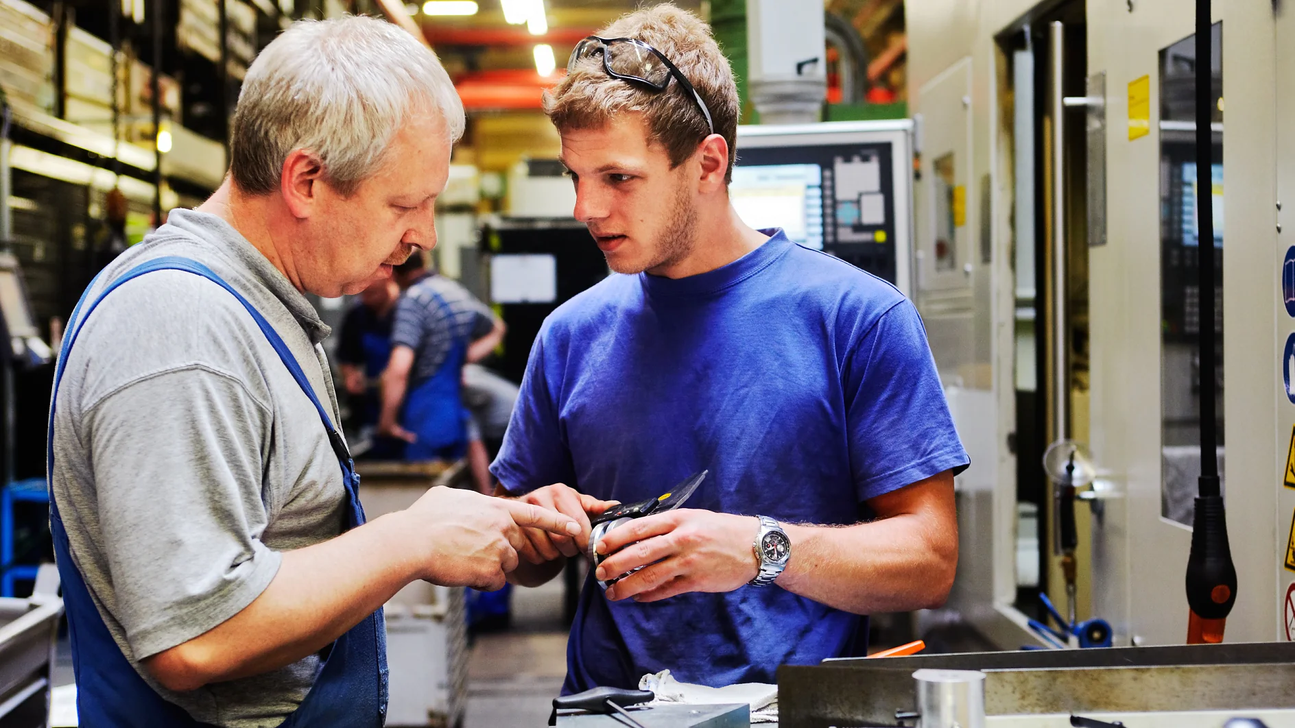 skilled workers controlling a workpiece