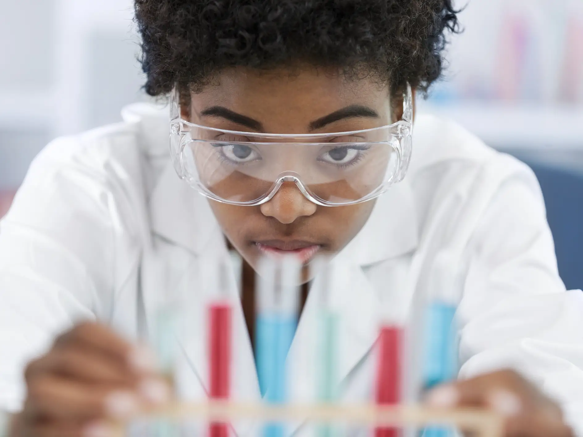 woman with glasses holds samples in her hands