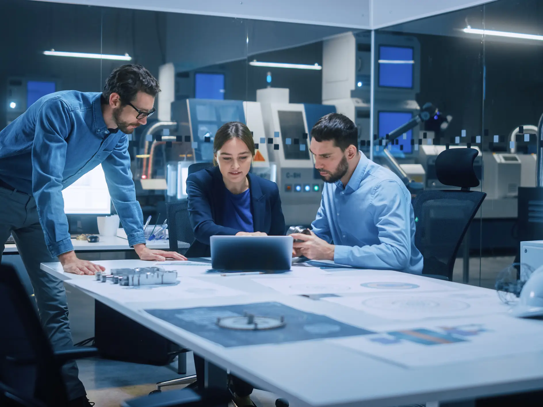 Factory Office Meeting Room: Team of Engineers Gather Around Conference Table, They Discuss Project Blueprints, Inspect Mechanism, Find Solutions, Use Laptop. Industrial Technology Factory