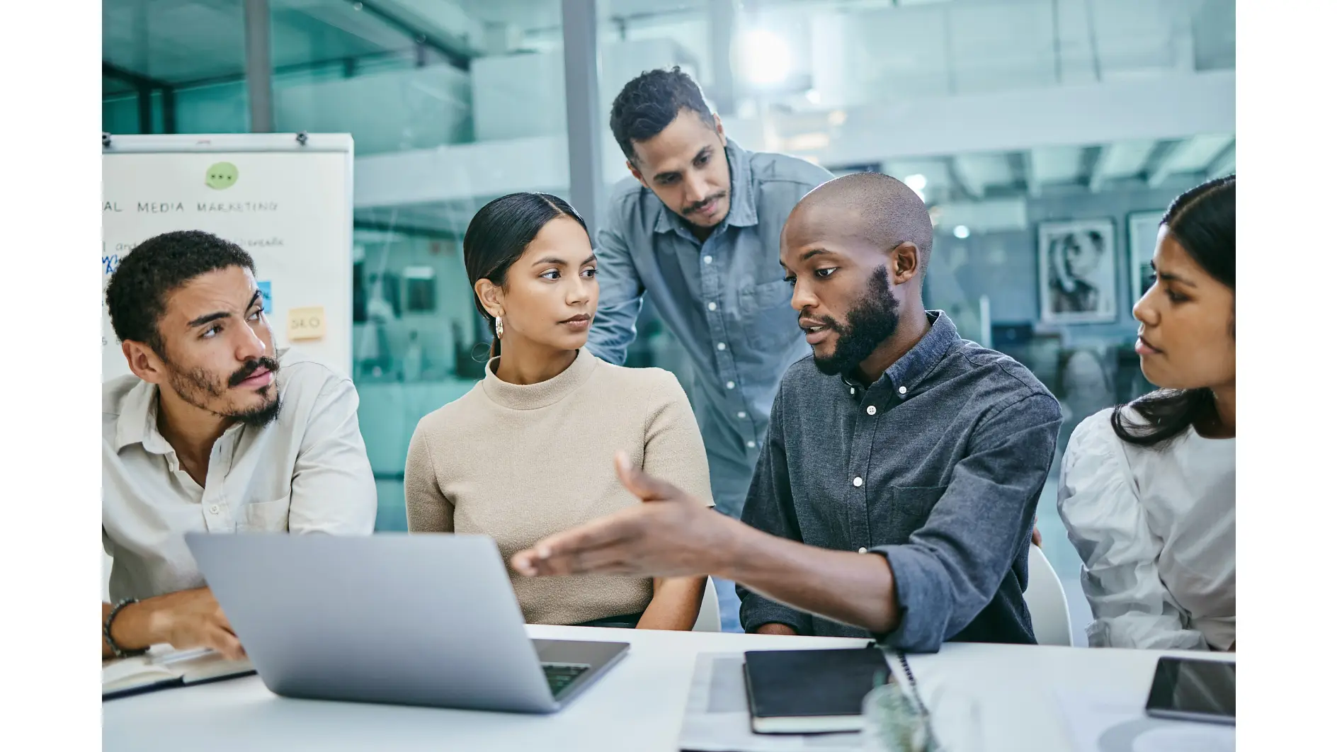 Shot of a group of businesspeople using a laptop during a meeting.