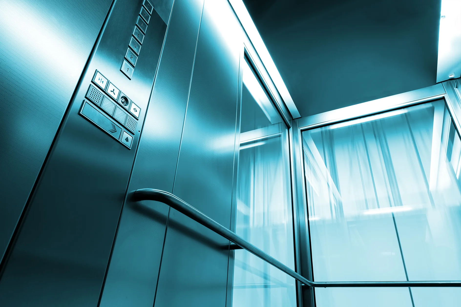 Inside metal and glass Elevator in modern building , the shiny button railings