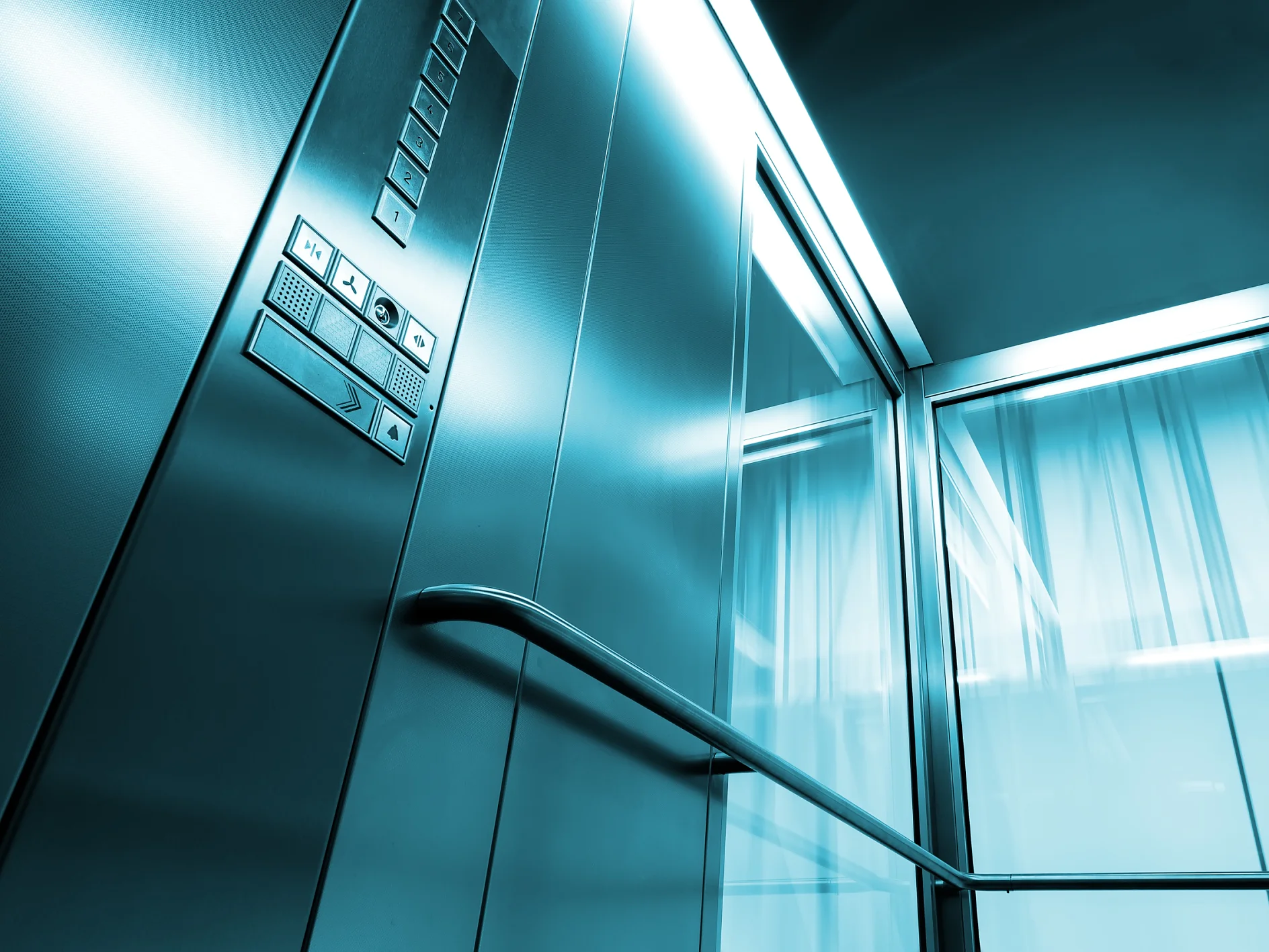 Inside metal and glass Elevator in modern building , the shiny button railings