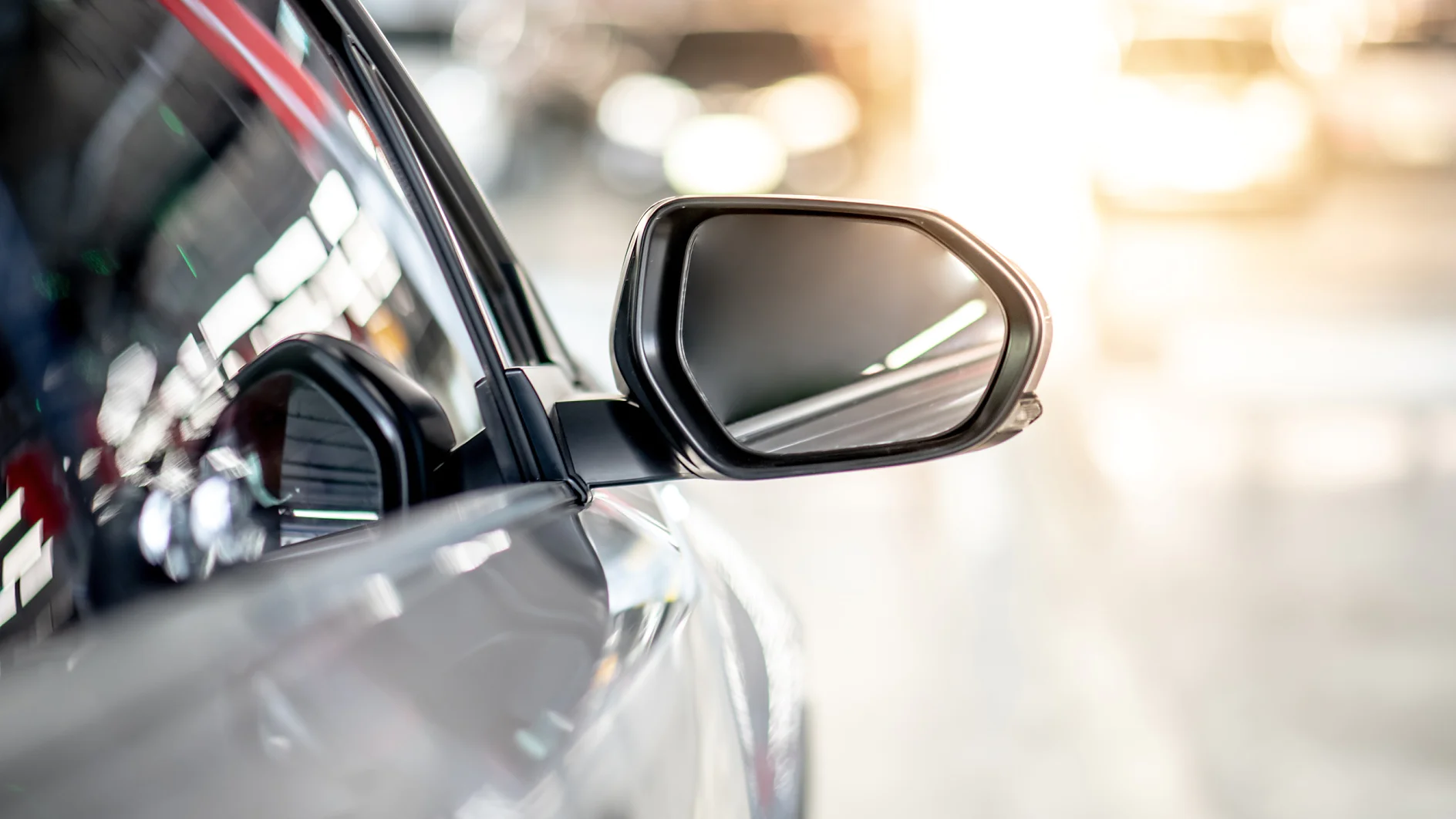 Close up of metallic wing mirror of modern car. Auto transport or automobile industry concepts